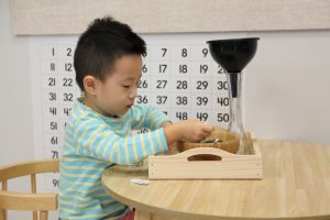 young child plays with a science set