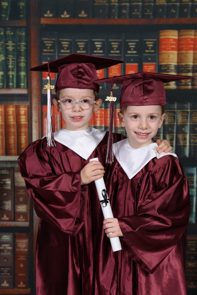 twin brothers in cap and gown for graduation