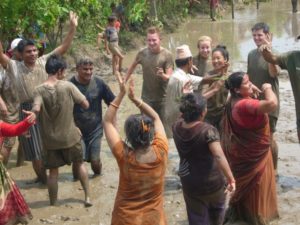 People dancing in the mud